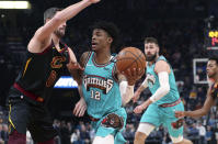 Memphis Grizzlies guard Ja Morant (12) looks to pass the ball as Cleveland Cavaliers forward Kevin Love (0) defends during the first half of an NBA basketball game Friday, Jan. 17, 2020, in Memphis, Tenn. (AP Photo/Karen Pulfer Focht)