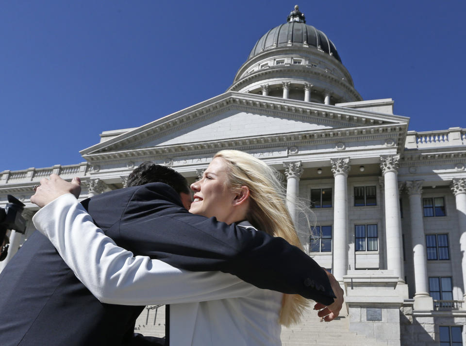 Elizabeth Smart receives a hug before speaking at a news conference Thursday, Sept. 13, 2018, in Salt Lake City. Smart says it appears there is no viable, legal recourse she can take to stop the release of one of her kidnappers. Smart said that she only found out about 72-year-old Wanda Barzee's release shortly before the public did. (AP Photo/Rick Bowmer)
