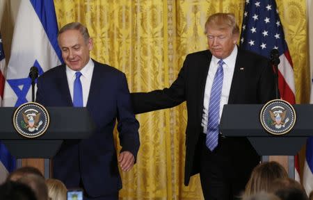 U.S. President Donald Trump (R) greets Israeli Prime Minister Benjamin Netanyahu at a joint news conference at the White House in Washington, U.S., February 15, 2017. REUTERS/Kevin Lamarque