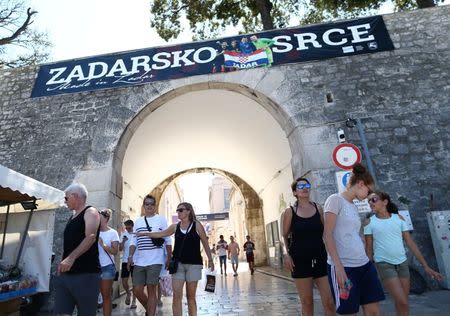 People walk under a football-themed "Zadar's heart" banner in Zadar, Croatia, July 14, 2018. REUTERS/Antonio Bronic