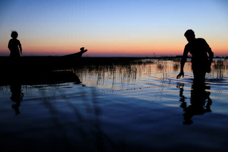 An Iraqi Marsh Arab man fishes at the Chebayesh marsh in Dhi Qar province, Iraq April 13, 2019. Picture taken April 13, 2019. REUTERS/Thaier al-Sudani