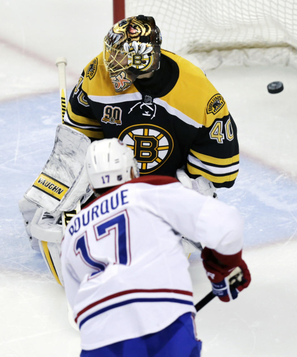 Boston Bruins goalie Tuukka Rask (40) misses a shot by Montreal Canadiens left wing Rene Bourque (17) during the second period of Game 1 in the second-round of a Stanley Cup playoff series in Boston, Thursday, May 1, 2014. (AP Photo/Charles Krupa)