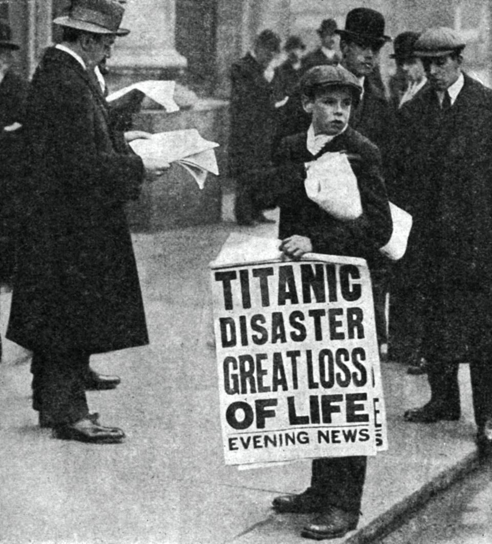 Newspaper boy with news of the Titanic disaster, 14 April 1912.