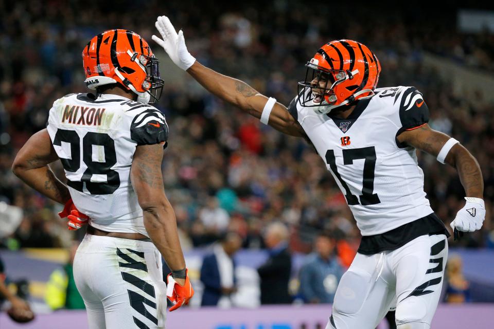 Cincinnati Bengals running back Joe Mixon (28) celebrates a touchdown with wide receiver Stanley Morgan (17) in the second quarter of the NFL Week 8 game between the Los Angeles Rams and the Cincinnati Bengals at Wembley Stadium in Wembley, London, on Sunday, Oct. 27, 2019. 