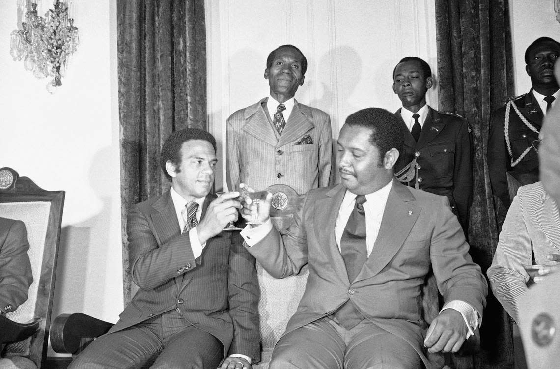 United Nations Ambassador Andrew Young, left, joins Haiti’s President for-life Jean-Claude Duvalier in a toast after their meeting, Monday, August 15, 1977 in Port-au-Prince, Haiti. Pursuing the Carter administration’s policy of the protection of human rights, Young told Duvalier that “freedom contributes more to stability than repression.”