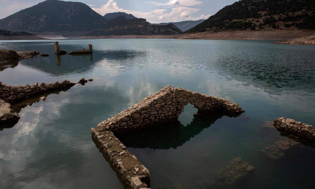 <span>‘Nightmarish situation’: Buildings from the flooded village of Kallio have begun to re-emerge from the Mornos reservoir.</span><span>Photograph: Yannis Kolesidis/EPA</span>