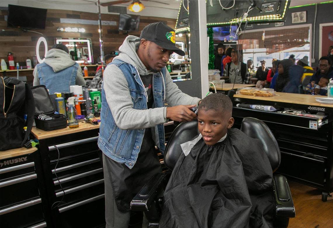 Joseph Long, 9, was one of the many children who received a free haircut from stylist Amodre Crawford at Draques’s Barbershop on Sunday.