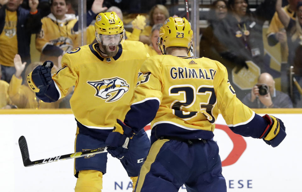 Nashville Predators center Rocco Grimaldi (23) celebrates with Austin Watson (51) after scoring a goal against the Dallas Stars during the second period in Game 2 of an NHL hockey first-round playoff series Saturday, April 13, 2019, in Nashville, Tenn. (AP Photo/Mark Humphrey)