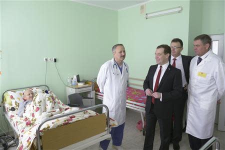 Russia's Prime Minister Dmitry Medvedev (2nd R, front) visits a children's hospital in the Crimean city of Simferopol, March 31, 2014. REUTERS/RIA Novosti/Alexander Astafyev/Pool