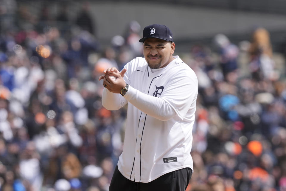 Detroit Lions offensive tackle Penei Sewell prepares to throw out the ceremonial first pitch before a baseball game between the Detroit Tigers and the Oakland Athletics, Friday, April 5, 2024, in Detroit. (AP Photo/Carlos Osorio)