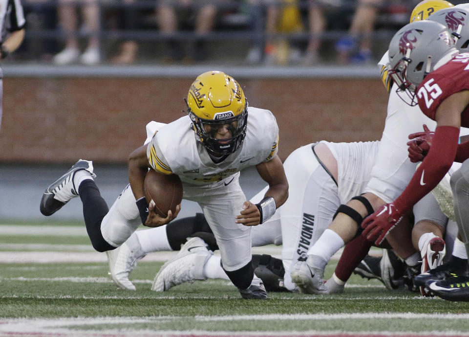 Idaho quarterback Gevani McCoy dives for a first down as Washington State defensive back Jaden Hicks, right, closes in during the first half of an NCAA college football game Saturday, Sept. 3, 2022, in Pullman, Wash. (AP Photo/Young Kwak)