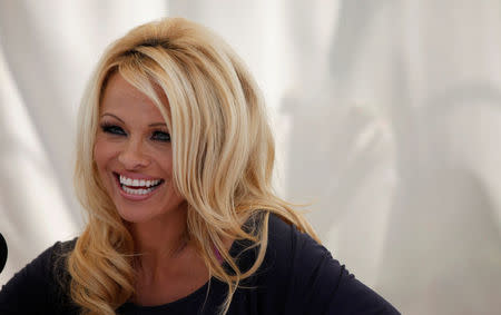 FILE PHOTO: Actress Pamela Anderson answers a question at a news conference to announce the launch of the online social platform FrogAds.com, in West Hollywood, California March 22, 2012. REUTERS/Mario Anzuoni/File Photo