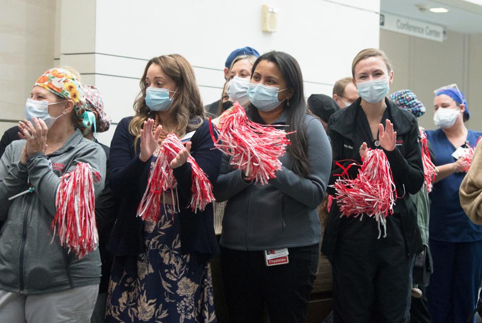 Health professionals applaud as Manchester Township Police Lieutenant Antonio Ellis, who was among the first severe COVID-19 cases in New Jersey in mid-March 2020, returned to Cooper University Hospital in Camden on Monday, November 22, 2021, to thank the team of caregivers who saved his life.