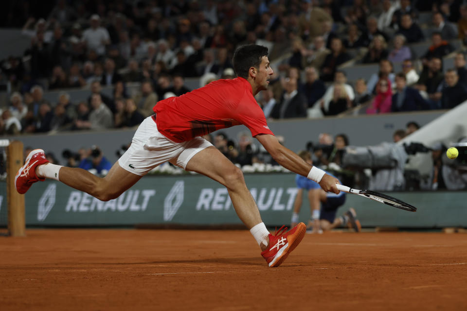 Serbia's Novak Djokovic tries to return the ball to Spain's Rafael Nadal during their quarterfinal match of the French Open tennis tournament at the Roland Garros stadium Tuesday, May 31, 2022 in Paris. (AP Photo/Jean-Francois Badias)