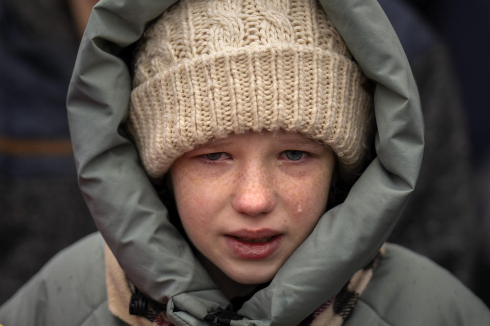 FILE - Anna, 10, cries next to the body of her brother Yurii Kulyk, 27, a civilian volunteer in the armed forces of Ukraine killed in a rocket attack on Feb.15 in Lyman, during his funeral in Kalynivka, near Kyiv, Ukraine, Tuesday, Feb. 21, 2023. An international arrest warrant for President Vladimir Putin raises the prospect of justice for the man whose country invaded Ukraine but complicates efforts to end that war in peace talks. (AP Photo/Emilio Morenatti, File)