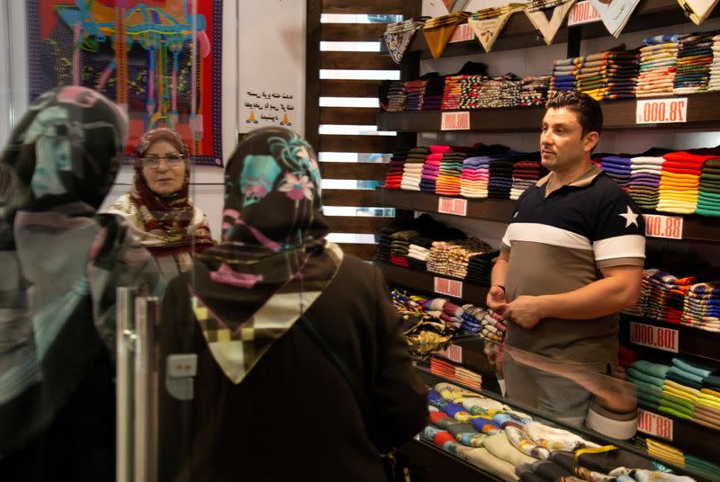 FILE PHOTO: Women shop for scarves of Iranian scarf brand Devora at Kourosh mall in western Tehran