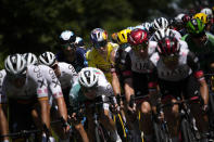 Belgium's Wout Van Aert, wearing the overall leader's yellow jersey rides in the pack during the fourth stage of the Tour de France cycling race over 171.5 kilometers (106.6 miles) with start in Dunkerque and finish in Calais, France, Tuesday, July 5, 2022. (AP Photo/Daniel Cole )
