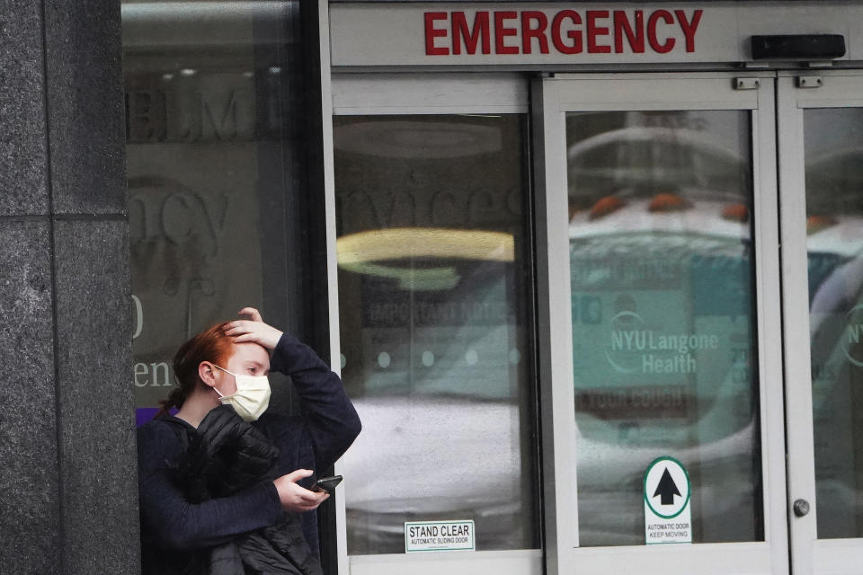 A person stands outside a hospital emergency ward wearing a protective mask following the outbreak of Coronavirus disease (COVID-19), in the Manhattan borough of New York City, New York, U.S., March 23, 2020. REUTERS/Carlo Allegri