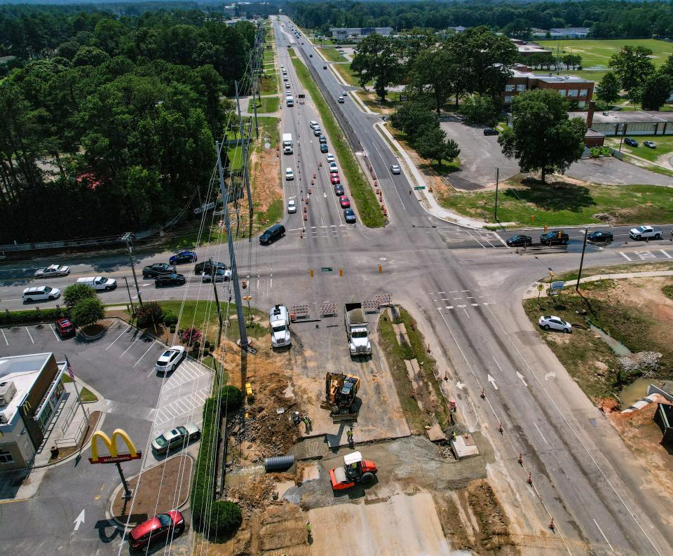 Construction crew works on repairing a large sinkhole on Raeford Road at 71st School Road and Graham Road on Tuesday, June 27, 2023. 