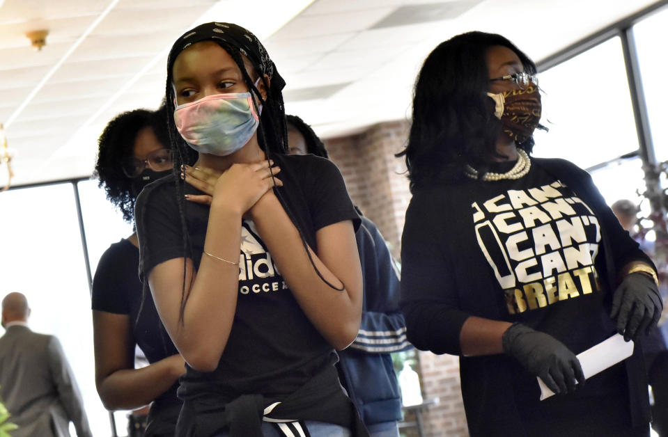 People pay their respects during a memorial service for George Floyd, Saturday, June 6, 2020, in Raeford, N.C. Floyd died after being restrained by Minneapolis police officers on May 25. (Ed Clemente/The Fayetteville Observer via AP, Pool)