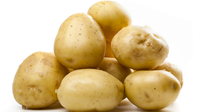 Potatoes over white background