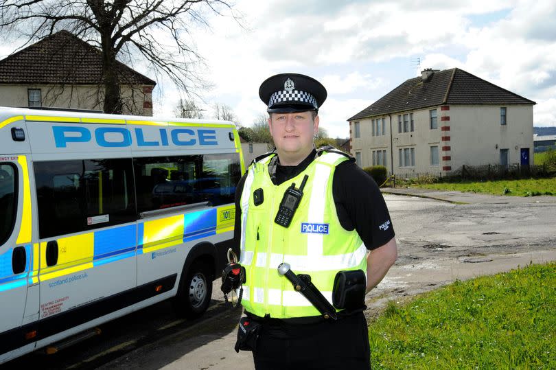 Sergeant Craig Marshall at the Tannahill Estate in Paisley with a police van behind him