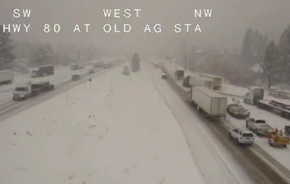 In this image taken from video from a Caltrans remote video traffic camera, traffic moves slowly through the snowy conditions along Interstate 80 near Truckee, Calif., Tuesday, Nov. 8, 2022. A major winter storm pounded California on Tuesday, bringing rain and snow to the drought-stricken state along with possible flash flooding in areas recently scarred by wildfires, meteorologists said. (Caltrans via AP)