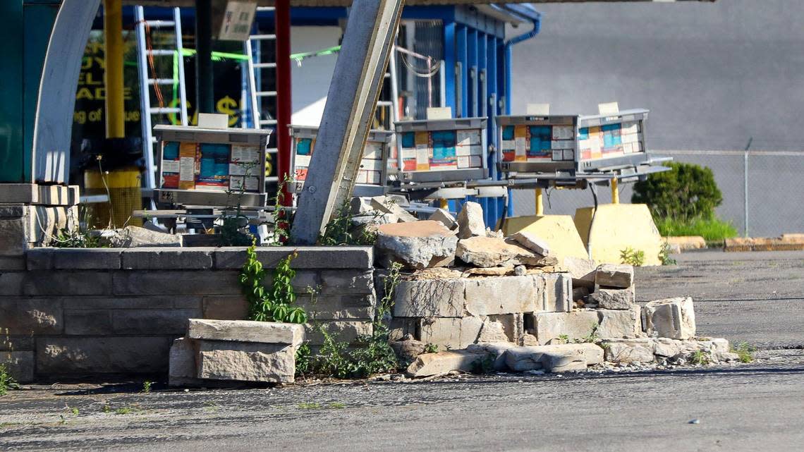 A stone wall lies partially fallen apart at the base of the iconic Parkette Drive-In neon sign for the restaurant on New Circle Road, June 29, 2022. The long-time Lexington, Ky. restaurant, known for its fried chicken and fish served in boxes and “Poor Boy” double-decker burgers, closed after more than 70 years in business on June 28, 2022.