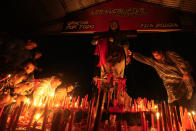 A woman touches a figure of Argentina's folk Saint "Gauchito" Gil at his sanctuary in Mercedes, Corrientes, Argentina, Sunday, Jan. 7, 2024. Every Jan. 8, devotees from across the country visit his sanctuary to ask for miracles or give him thanks.(AP Photo/Natacha Pisarenko)