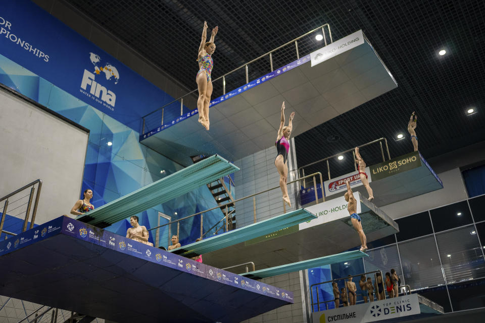 Children jump into the water during training in Kyiv's Liko Diving School, Wednesday, July 3, 2024. At Ukraine's largest diving school, 50% of the most promising children here are gone, said Illia Tseliutin, head coach of Ukraine's national diving team. Two of the 20 coaches joined the army and three fled the country. (AP Photo/Alex Babenko)