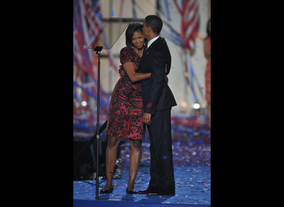 Democratic presidential nominee Barack Obama kisses his wife Michelle on stage at the end of the Democratic National Convention 2008 at the Invesco Field in Denver, Colorado, on August 28, 2008. Obama formally accepted the party's presidential nomination before a capacity crowd of 75,000 delirious supporters, becoming the first-ever black major-party White House pick, exactly 45 years after Martin Luther King's 'I have a dream' anthem to racial harmony. (Photo: PAUL J. RICHARDS/AFP/Getty Images)
