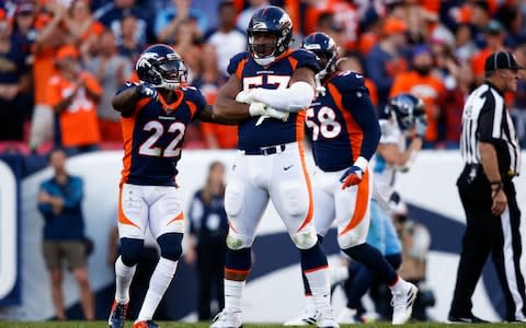 Denver Broncos defensive end DeMarcus Walker (57) celebrates with defensive back Kareem Jackson (22) after a play in the fourth quarter against the Tennessee Titans at Empower Field at Mile High - Credit: USA Today
