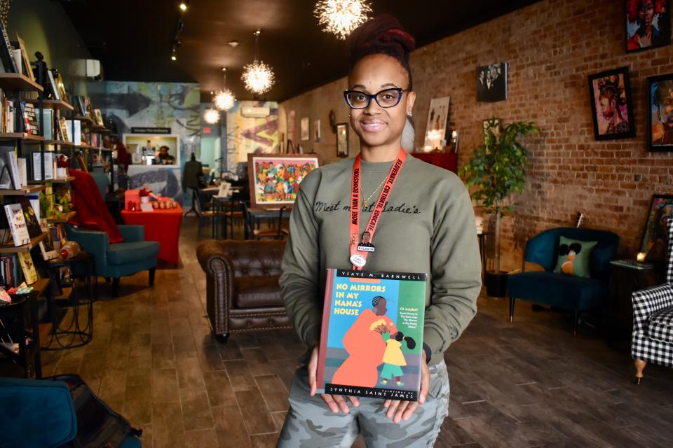 Yaa Yaa Whaley-Williams, owner of Sadie's Books & Beverages in Middletown, holds the last book her grandmother Sadie gifted her before her passing.