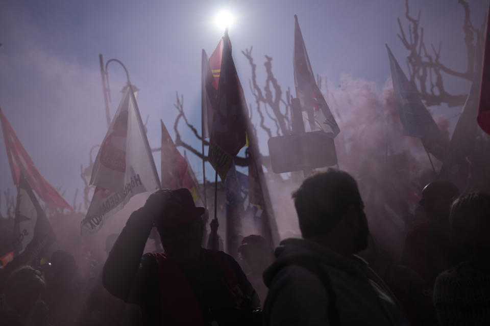 People demonstrate before French President Emmanuel Macron's visit, Thursday, April 20, 2023 in Ganges, southern France. The French leader tries to repair damage done to his presidency by forcing through unpopular pension reforms. Raising the retirement age from 62 to 64 has ignited a months-long firestorm of protest in France. (AP Photo/Daniel Cole)