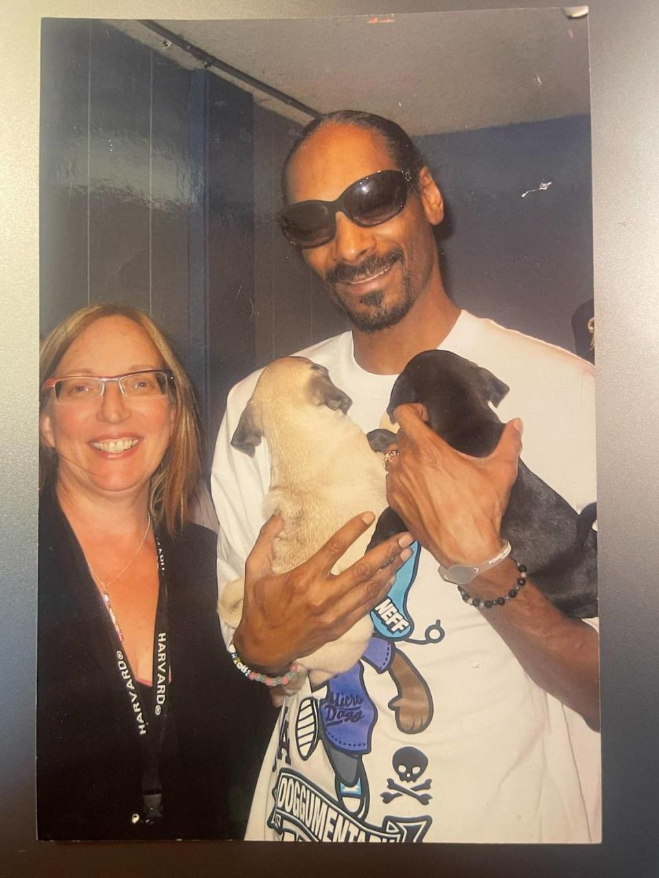 Catherine Leslie and Snoop Dogg, who is holding her dogs, Louie, left, and Dolly.