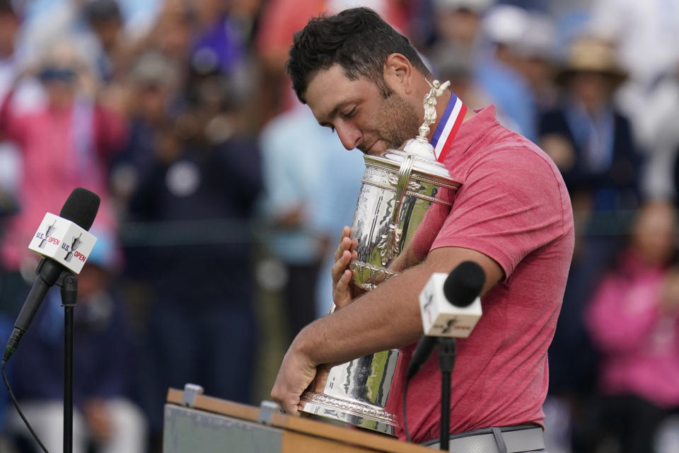 Jon Rahm, of Spain, holds the champions trophy after the final round of the U.S. Open Golf Championship, Sunday, June 20, 2021, at Torrey Pines Golf Course in San Diego. (AP Photo/Gregory Bull)