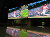 A customer watches a Washington Nationals batter hitting a home run on a giant video screen in the sports betting lounge at the Tropicana casino in Atlantic City N.J. on Thursday, May 12, 2022. American gamblers have wagered over $125 billion on sports with legal betting outlets in the four years since the U.S. Supreme Court cleared the way for all 50 states to offer legal sports betting; about two thirds currently do.(AP Photo/Wayne Parry)