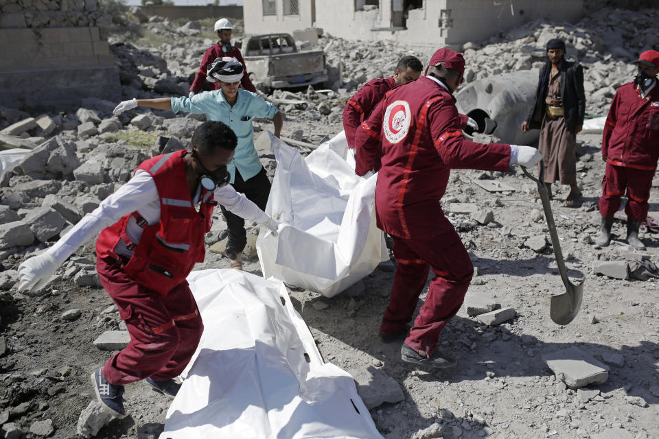 Rescue workers recover bodies from under the rubble of a Houthi detention center destroyed by Saudi-led airstrikes, that killed at least 60 people and wounding several dozen according to officials and the rebels' health ministry, in Dhamar province, southwestern Yemen, Sunday, Sept. 1, 2019. The officials said the airstrikes took place Sunday and targeted a college in the city of Dhamar, which the Houthi rebels use as a detention center. The Saudi-led coalition said it had hit a Houthi military facility used as storages for drones and missiles in Dhamar. (AP Photo/Hani Mohammed)