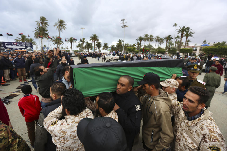 Mourners carry coffins during a funeral of military cadets in Tripoli, Libya, Sunday, Jan. 5, 2020. Health officials said the death toll from the airstrike climbed to at least 30 people, most of them students and over 30 others were wounded. The airstrike took place in the city's south late Saturday, an area which has seen heavy clashes in recent months. Forces based in eastern Libya and led by Gen. Khalifa Hifter have been fighting to seize the capital from the weak but U.N.-supported government. (AP Photo/Hazem Ahmed)