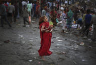 <p>A Hindu devotee dances in a trance on the banks of the River Yamuna during Durga Puja festival in New Delhi, India, Saturday, Sept. 30, 2017. The idols of goddess Durga are immersed on the final day of the festival that commemorates the slaying of a demon king by lion-riding, 10-armed goddess Durga, marking the triumph of good over evil. (Photo: Altaf Qadri/AP) </p>