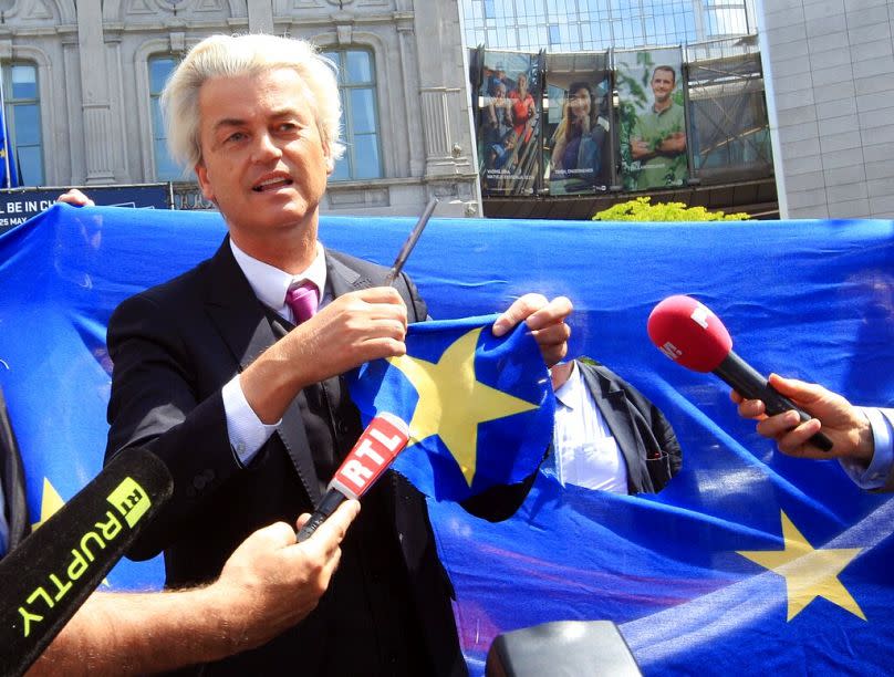 Geert Wilders displays a yellow star he cut out of the EU flag in front of the European Parliament in Brussels, 2014.