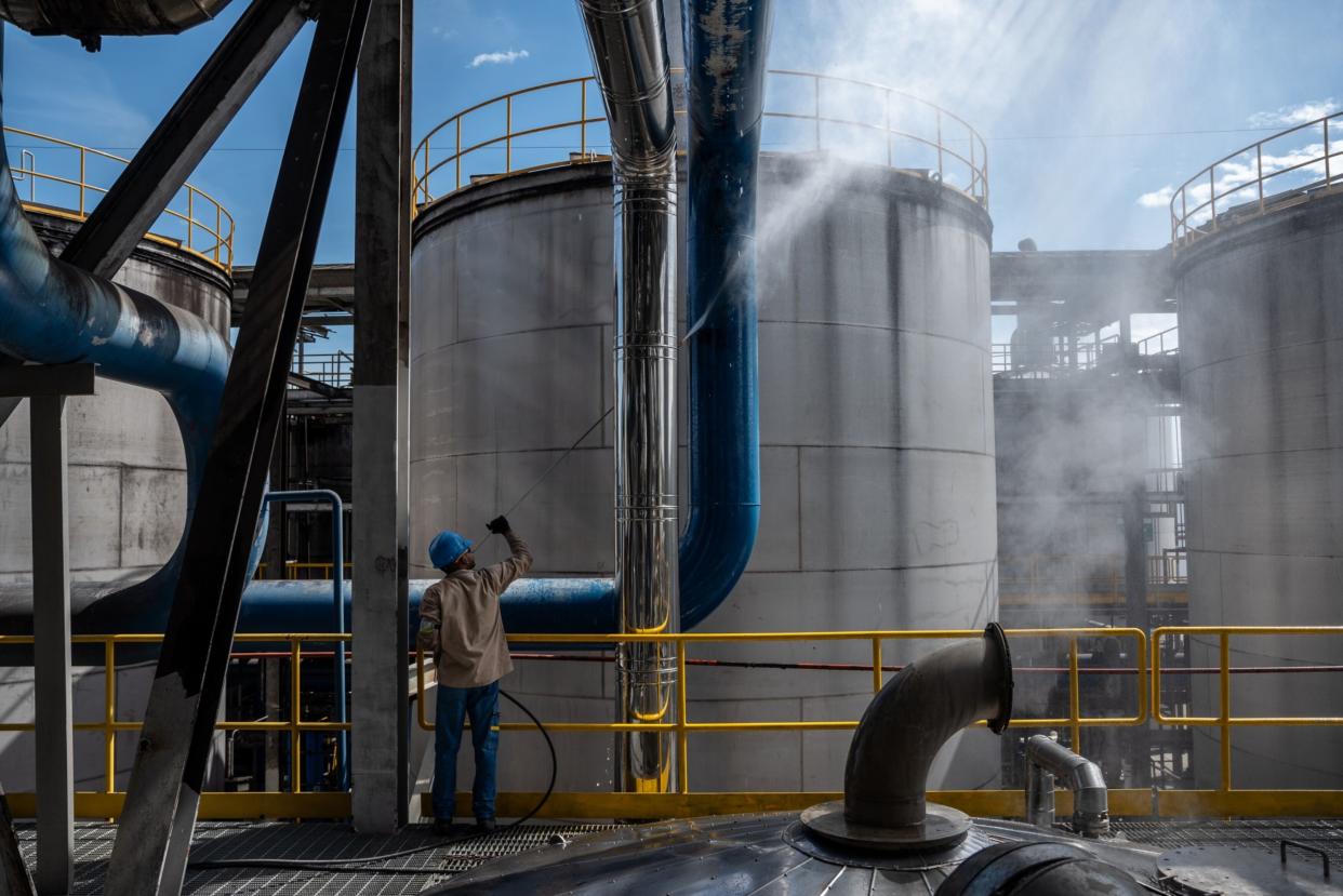 A worker cleans a pipe at the Riopaila Castilla ethanol distillery in Zarzal, Valle del Cauca department, Colombia, on Tuesday, July 11, 2023. The Colombian Biofuel industry makes more than US$1.3 billion in sales every year, and according to Fedebiocombustibles, biofuels will increase their importance in global demand by 2050. (Jair Fernando Coll Rubiano/Bloomberg)