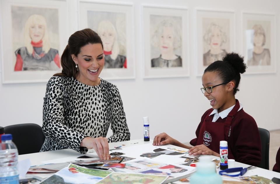 Britain's Catherine (L), Duchess of Cambridge, helps a student from Holy Trinity and St John's Primary School with a collage art project during a visit to Turner Contemporary art gallery in Margate, southern England on March 11, 2015. AFP PHOTO / POOL / SUZANNE PLUNKETT        (Photo credit should read SUZANNE PLUNKETT/AFP via Getty Images)