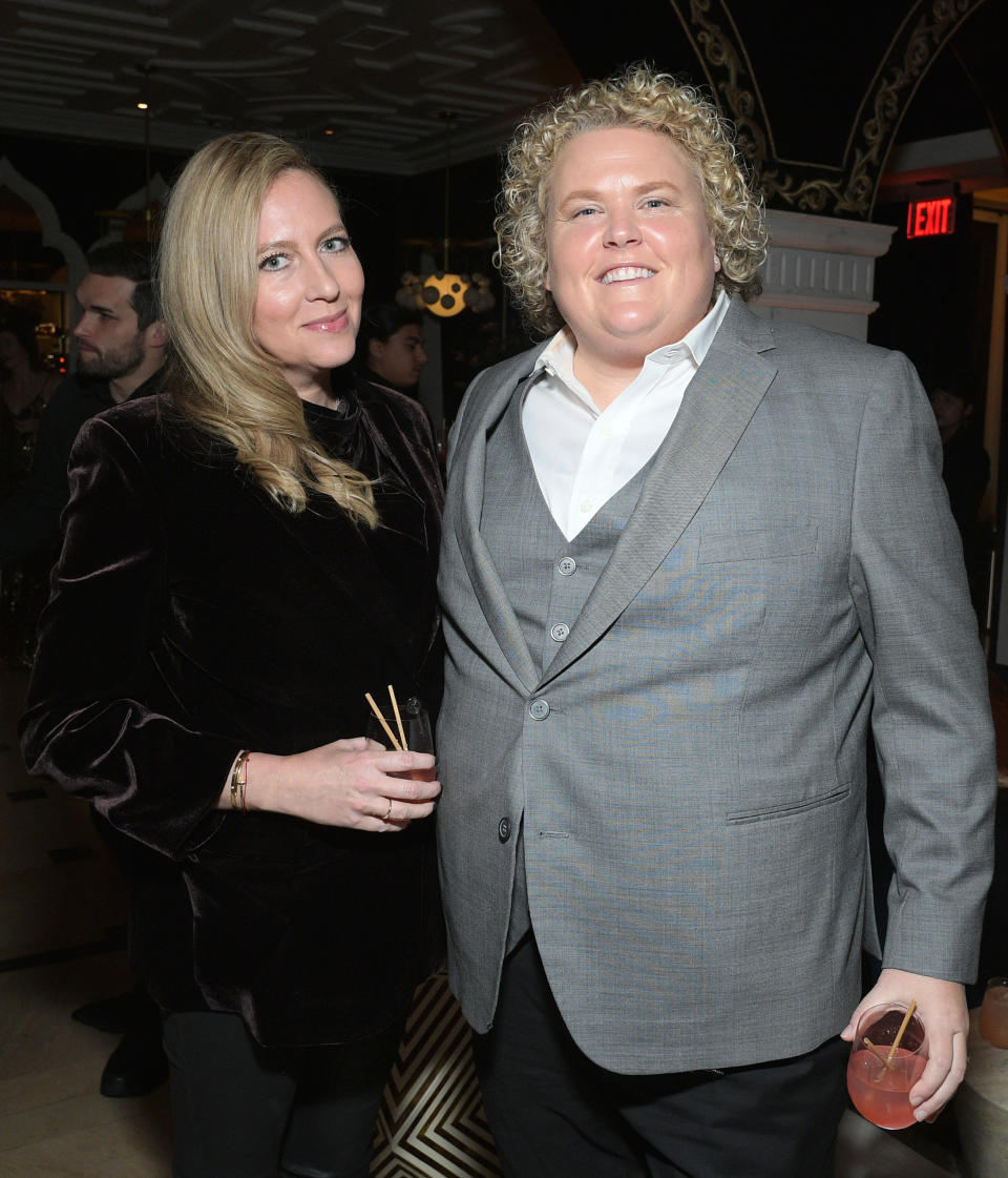 Fortune Feimster and Jacquelyn Smith at an event, Fortune in a grey suit and open-collar shirt, and Jacquelyn in a dark, velvet-like outfit