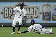 Kansas City Royals center fielder Michael A. Taylor (2) and shortstop Bobby Witt Jr. (7) try to field a single hit by Chicago White Sox's Leury Garcia during the fourth inning of a baseball game Monday, May 16, 2022, in Kansas City, Mo. (AP Photo/Charlie Riedel)