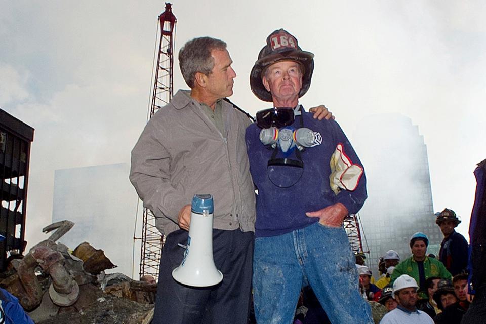 The New York City Fire Department announced on Monday the death of retired firefighter Robert Beckwith, right, who rushed to the scene of the Sept. 11, 2001 attacks and became famous for standing next to President George W. Bush on the ruins of the World Trade Center.