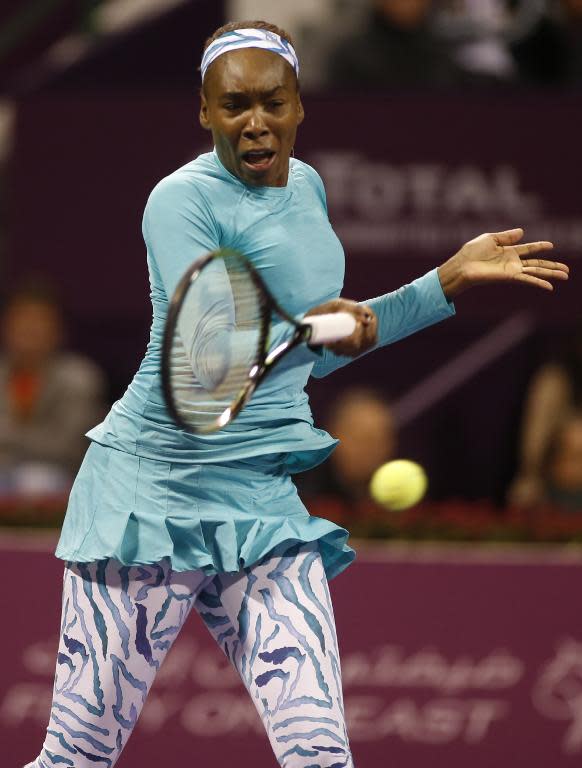 Venus Williams of the USA returns the ball to Victoria Azarenka of Belarus during their women's singles semi-final tennis match in the Qatar Open tennis tournament on February 27, 2015 in Doha