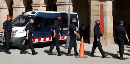 FILE PHOTO: Mossos d'Esquadra, Catalan regional police officers, walk in a line outside the Catalonian regional parliament in Barcelona, Spain, October 10, 2017. REUTERS/Rafael Marchante/File Photo