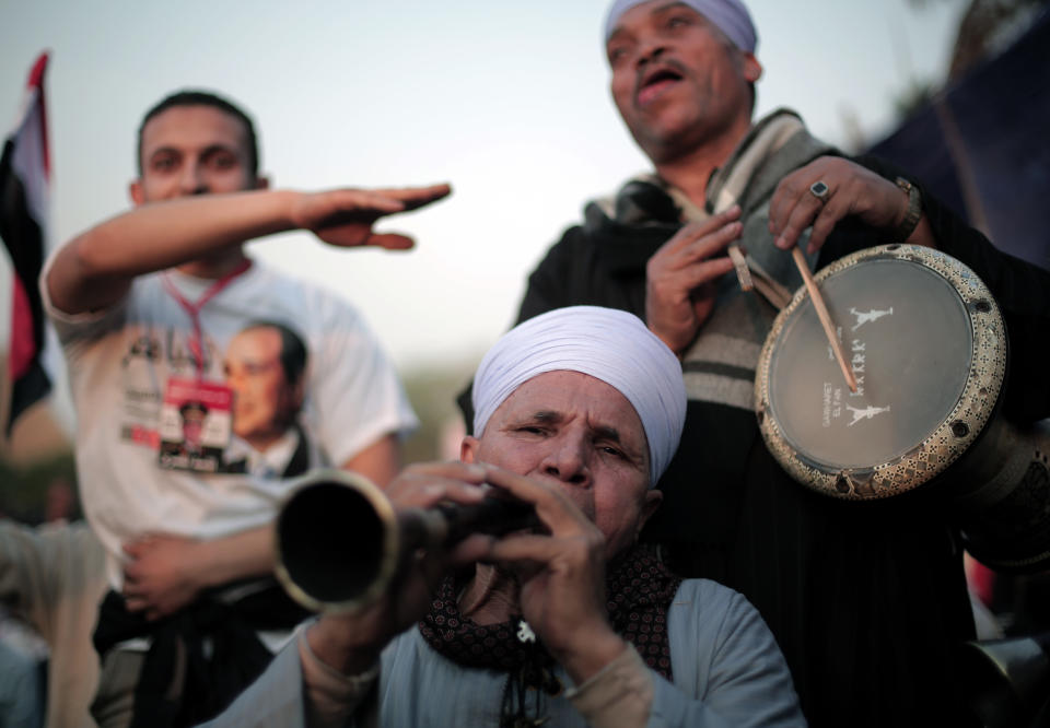 Egyptian supporters of presidential candidate, Abdel-Fattah el-Sissi, chant slogans and dance during a campaign rally in Cairo, Egypt, Saturday, May 10, 2014. El-Sissi, is seen as the overwhelming favorite to win the May 26-27 election. So far, el-Sissi, is riding an overwhelming media frenzy lauding him as Egypt’s savior for overthrowing Morsi last summer. (AP Photo/Khalil Hamra)