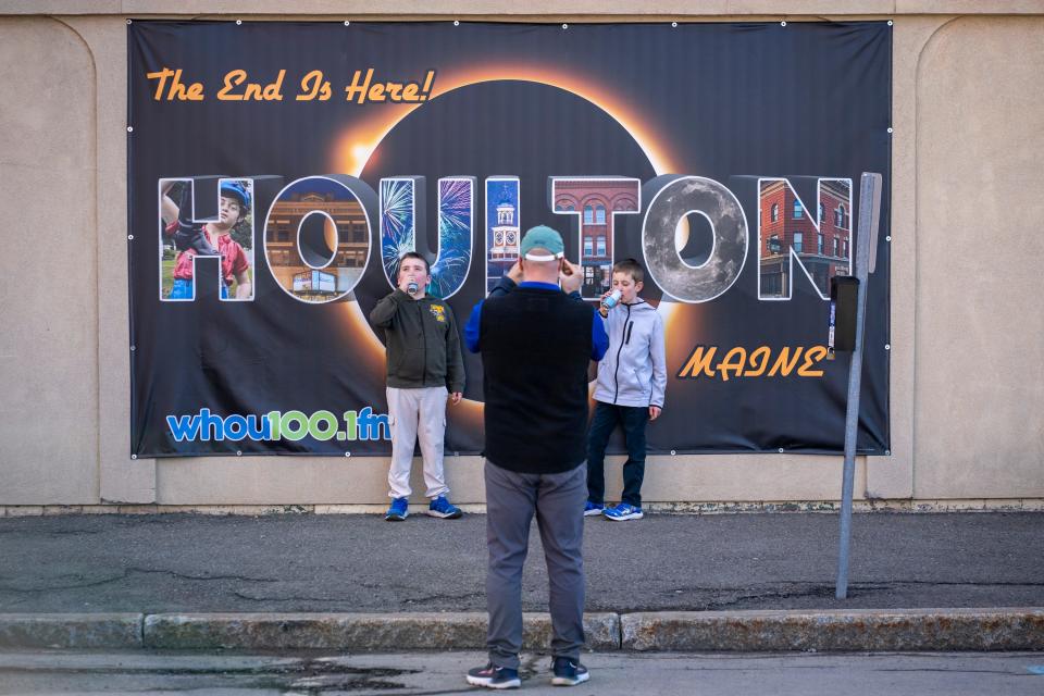 Jerry (center) and his sons Sterling (left) and Graysen (right) from Dedham, Maine, stop for a photo on April 8, 2024 in Houlton, Maine, the easternmost city in the United States in the path of the total solar eclipse.